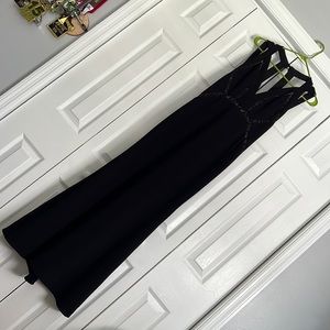 Floor length sexy black dress with straps and sheer lace details.